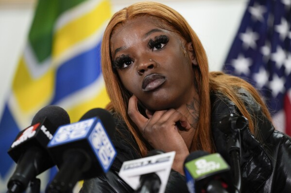 Majiah Washington listens to a question during a news conference at the Portland Fire & Rescue headquarters on Thursday, Jan. 18, 2024, in Portland, Ore. A power line fell on a parked car in northeast Portland on Wednesday, killing three people and injuring a baby during an ice storm. Washington, who saw the incident unfold through her window, rushed outside to grab the baby from one of the people lying in the street to save its life. (AP Photo/Jenny Kane)