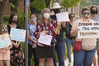 Parents and students hold rally at Utah State School Board Office calling for mask mandate Friday, Aug. 6, 2021, in Salt Lake City. The school year is days away for many kids in Utah and public health experts are worried about whether kids too young to get vaccinated will stay safe in school amid a wave of coronavirus cases. (AP Photo/Rick Bowmer)