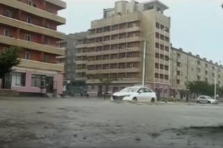 In this image taken from undated North Korean state broadcaster video, vehicles pass through flooded streets after heavy rains across  South Hamgyong Province, North Korea. (KRT via APTV)