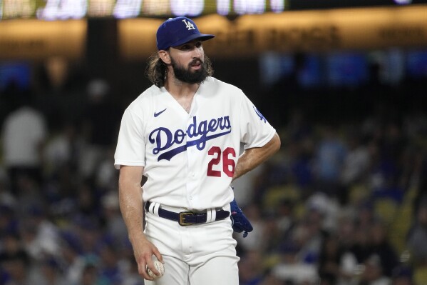 Los Angeles Dodgers starting pitcher Tony Gonsolin stands on the mound as manager Dave Roberts comes to take him out during the fourth inning of a baseball game against the Miami Marlins Friday, Aug. 18, 2023, in Los Angeles. (AP Photo/Mark J. Terrill)