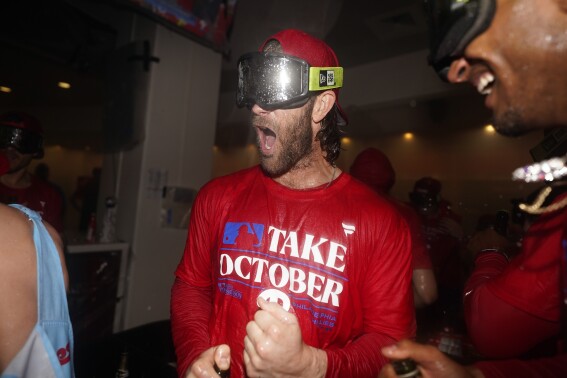 Philadelphia Phillies' Bryce Harper celebrates after winning a baseball game against the Pittsburgh Pirates to clinch a wild-card playoff spot, Tuesday, Sept. 26, 2023, in Philadelphia. (AP Photo/Matt Slocum)