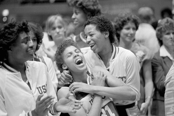 FILE - University of Southern California's Cheryl Miller, center left, and Cynthia Cooper, center right, rejoice after winning the NCAA women's basketball championship by defeating the University of Tennessee 72-61 in Los Angeles, April 1, 1984. (AP Photo/Lennox McLendon, File)