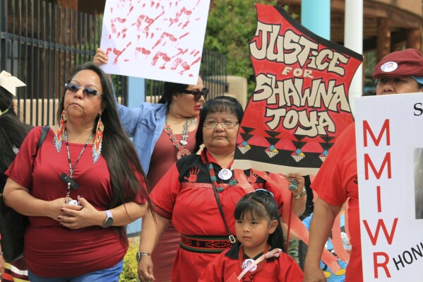 Geraldine Toya, center, marches to bring awareness to the death of her daughter Shawna Toya, in 2021, as dozens of people participate in Missing and Murdered Indigenous Persons Awareness Day in Albuquerque, N.M., Sunday, May 5, 2024. (AP Photo/Susan Montoya Bryan)