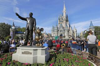 FILE - A statue of Walt Disney and Micky Mouse stands in front of the Cinderella Castle at the Magic Kingdom at Walt Disney World in Lake Buena Vista, Fla., Jan. 9, 2019. It’s going on six months since Bob Iger returned to The Walt Disney Co., and while there’s been plenty of issues to keep him busy, one has definitely been top of mind: reconnecting with the Disney theme park die-hards and restoring their faith in the brand. (AP Photo/John Raoux, File)