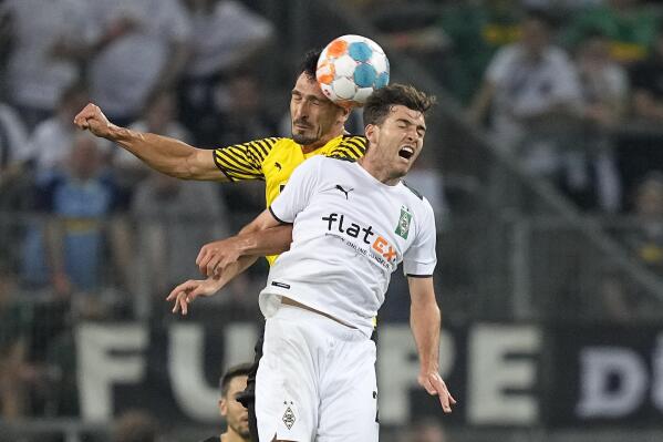 FILE - Dortmund's Mats Hummels, left, and Moenchengladbach's Joe Scally challenge for the ball during the German Bundesliga soccer match between Borussia Moenchengladbach and Borussia Dortmund in Moenchengladbach, Germany, Saturday, Sept. 25, 2021. Scally, an 18-year-old defender who has become a starter for Monchengladbach this season, was the lone first-time callup on the 25-man roster for United States' World Cup qualifiers against Mexico on Nov. 12 at Cincinnati and at Jamaica four days later. (AP Photo/Martin Meissner, File)