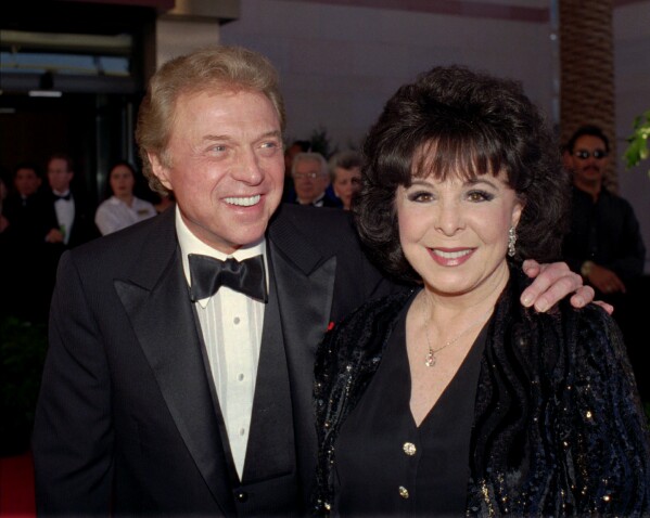 FILE - Singer Steve Lawrence, left, and his wife Eydie Gorme arrive at a black-tie gala called honoring Frank Sinatra in Las Vegas on May 30, 1998. Lawrence, a singer and top stage act who as a solo performer and in tandem with his wife Gorme kept Tin Pan Alley alive during the rock era, died Wednesday, March 6, 2024 at age 88. Gorme died on Aug. 10, 2013. (AP Photo/Lennox McLendon, File)