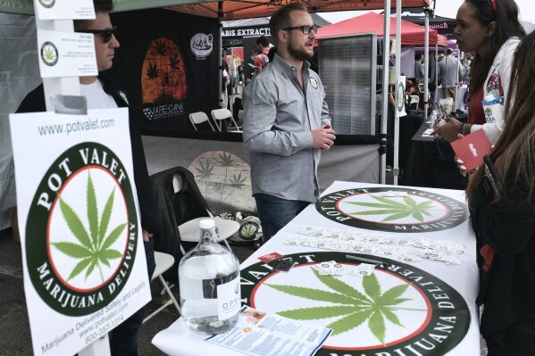 
              FILE - This March 31, 2018 photo shows a booth advertising a delivery service for cannabis at the Four Twenty Games in Santa Monica, Calif. Three California agencies released proposed regulations Friday, Dec. 7, 2018, for the state's marijuana industry including deliveries that will become permanent next month after state lawyers finish their review of them. Law enforcement groups and cities with marijuana bans unsuccessfully fought against it. (AP Photo/Richard Vogel, File)
            