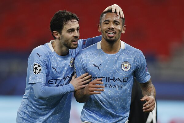Manchester City's Gabriel Jesus, right, celebrates with Manchester City's Bernardo Silva after scoring his side's second goal during the Champions League round of 16 first leg soccer match between Borussia Monchengladbach and Manchester City at the Puskas Arena stadium in Budapest, Hungary, Wednesday, Feb. 24, 2021. (AP Photo/Laszlo Balogh)