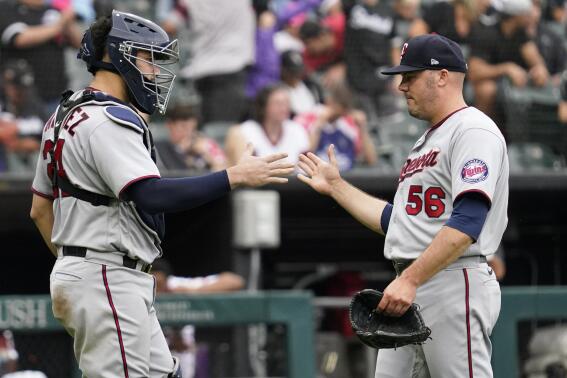 Minnesota Twins catcher Gary Sanchez, left, celebrates with relief pitcher Caleb Thielbar after they defeated the Chicago White Sox in a baseball game in Chicago, Sunday, Sept. 4, 2022. (AP Photo/Nam Y. Huh)