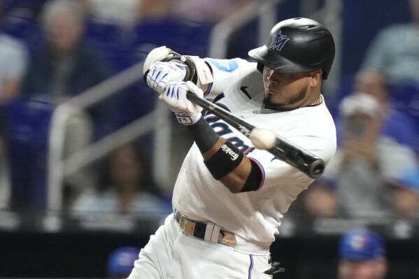 Miami Marlins' Luis Arraez hits a single during the seventh inning of a baseball game against the Toronto Blue Jays, Monday, June 19, 2023, in Miami. (AP Photo/Lynne Sladky)
