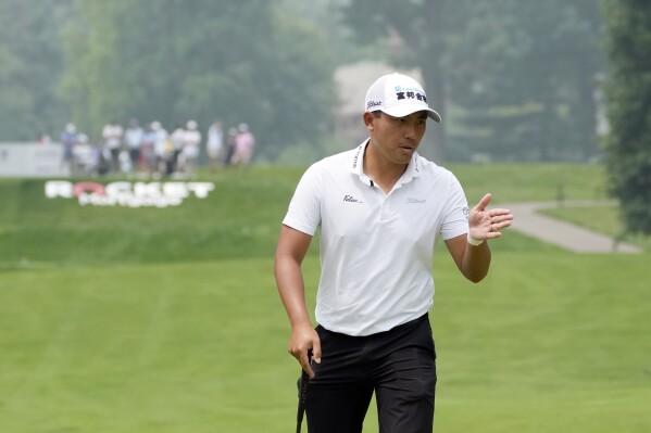 C.T. Pan, of Taiwan, gestures on the ninth green during a practice round of the Rocket Mortgage Classic golf tournament at Detroit Country Club, Wednesday, June 28, 2023, in Detroit, Mich. (AP Photo/Carlos Osorio)