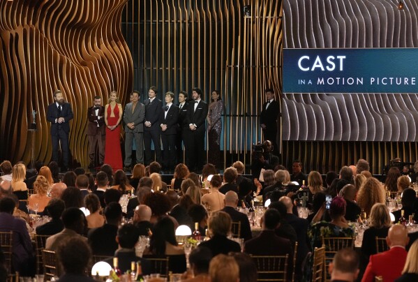 Kenneth Branagh, from left, David Krumholtz, Emily Blunt, Alden Ehrenreich, Robert Downey Jr., Josh Hartnett, Cillian Murphy, Casey Affleck, and Benny Safdie accept the award for outstanding performance by a cast in a motion picture for "Oppenheimer" during the 30th annual Screen Actors Guild Awards on Saturday, Feb. 24, 2024, at the Shrine Auditorium in Los Angeles. (AP Photo/Chris Pizzello)