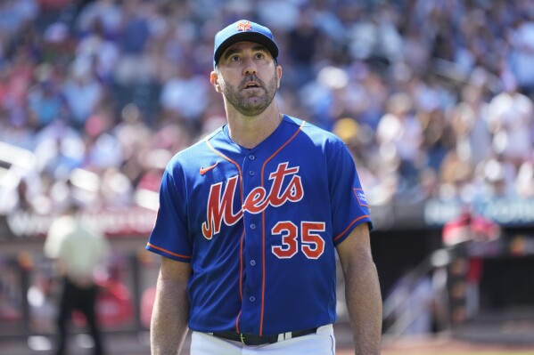 New York Mets' Justin Verlander looks at the fans applauding him as he leaves the field after being removed from a baseball game in the sixth inning against the Washington Nationals, Sunday, July 30, 2023, in New York. (AP Photo/Mary Altaffer)