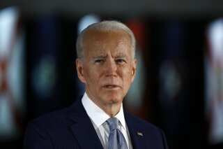 FILE - In this March 10, 2020, file photo Democratic presidential candidate former Vice President Joe Biden speaks to members of the press at the National Constitution Center in Philadelphia. Biden said Friday, May 29, that the "open wound” of systemic racism was behind the police killing of a handcuffed black man in Minnesota, and swiped at President Donald Trump for inciting violence, without mentioning him by name. "We are a country with an open wound. None of us can turn away,” Biden in a brief online address. (AP Photo/Matt Rourke, File)