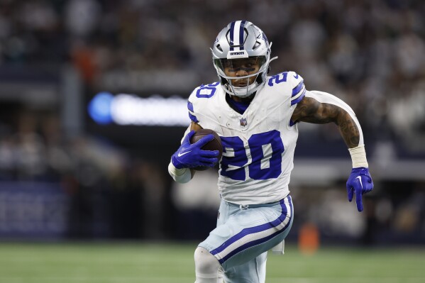 FILE - Dallas Cowboys running back Tony Pollard (20) carries the ball during an NFL wild-card playoff football game, Sunday, Jan. 14, 2024 in Arlington, Texas. Tony Pollard, Derrick Henry, Saquon Barkley, and Josh Jacobs are on the NFL's open market. (AP Photo/Matt Patterson, File)