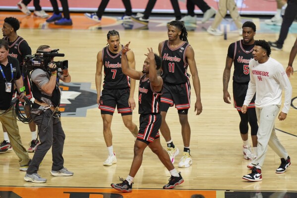 Houston's L.J. Cryer (4) celebrates with teammates after Houston beat Duke in the national semifinals at the Final Four of the NCAA college basketball tournament, Saturday, April 5, 2025, in San Antonio. (AP Photo/Stephanie Scarbrough)