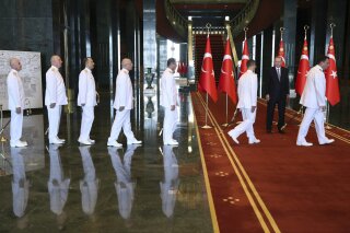 
              Turkey's President Recep Tayyip Erdogan, second right, receives greetings by naval officers on Victory Day at the Presidential Palace in Ankara, Turkey, Thursday, Aug. 30, 2018. Turkey celebrates Victory Day on Aug. 30, to mark the Turkish victory against Greek forces at the Battle of Dumlupinar, the crucial battle of the War of Independence in 1922 that led subsequently to the foundation of modern Turkish republic.  (Presidential Press Service via AP, Pool)
            