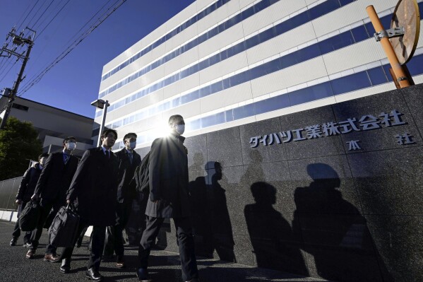 Japanese transport ministry officials arrive for the headquarters of Daihatsu Motor in Ikeda, Osaka, Thursday, Dec. 21, 2023. Japanese transport ministry officials inspected Toyota subsidiary Daihatsu on Thursday, one day after officials announced it was suspending the small car unit's shipments of all vehicles in and outside Japan after an investigation found improper testing involving 64 models. (Kyodo News via AP)