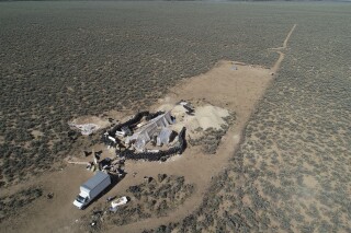 FILE - An aerial view of a makeshift compound is seen in the desert area of Amalia, N.M., Friday, Aug. 10, 2018. A video circulating on social media falsely claims that the compound is tied to the Hamas militant group. (AP Photo/Brian Skoloff, File)