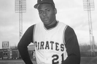 FILE - Roberto Clemente of the Pittsburgh Pirates is seen in Tampa, Fla., March 3, 1963. Fifty years after his death, Clemente, the skillful outfielder, remains one of the most revered figures in Puerto Rico and Latin America. His graceful flare and powerful arm were unrivaled in his era, but his humanitarian efforts are perhaps his greatest legacy. Half a century after he played, many of today’s Latino baseball players credit him for paving the way. (AP Photo/Preston Stroup, File)