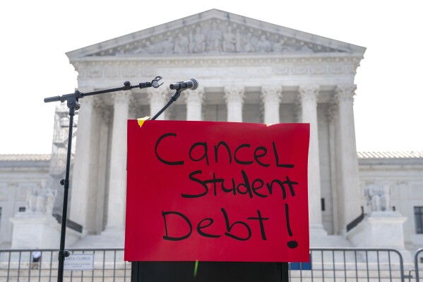 A sign reading "cancel student debt" is seen outside the Supreme Court, Friday, June 30, 2023, as decisions are expected in Washington. (AP Photo/Jacquelyn Martin)