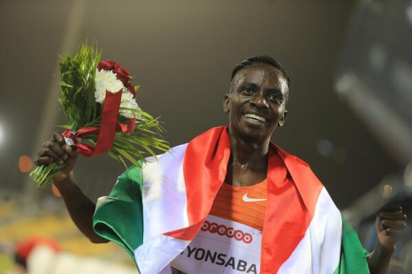 FILE - Francine Niyonsaba of Burundi celebrates winning the woman's 3000 meters at the Qatar Diamond League athletics meet in Doha, Qatar, May 13, 2022. Niyonsaba withdrew from the world championships Monday, July 11, 2022, with a foot injury, just when she looked to be a good bet for her first major medal in the 5,000 meters after being forced to switch to long-distance events by track and field's contentious testosterone rules. (AP Photo/Hussein Sayed, File)