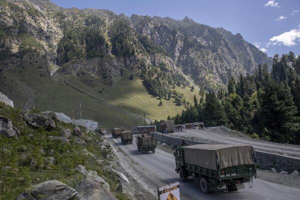 FILE - In this Sept. 9, 2020, file photo, an Indian army convoy moves on the Srinagar- Ladakh highway at Gagangeer, northeast of Srinagar, Indian-controlled Kashmir. Indian and Chinese army commanders met Sunday, Oct. 10, 2021 and discussed steps to disengage troops from key friction areas along their disputed border to ease a 17-month standoff that has sometimes led to deadly clashes, an Indian army spokesman said. (AP Photo/ Dar Yasin, File)