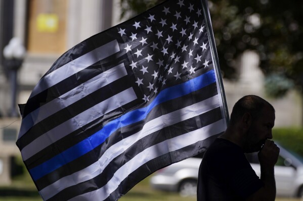 FILE - In this Aug. 30, 2020 file photo, an unidentified man participates in a Blue Lives Matter rally in Kenosha, Wis. A federal court has ruled that a Pennsylvania township cannot ban an American flag with a thin blue line from being publicly displayed, or prohibit use of its image by township employees, saying it is a violation of the First Amendment. (AP Photo/Morry Gash, File)