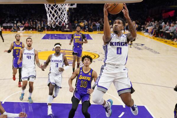 Sacramento Kings guard Malik Monk, right, shoots as Los Angeles Lakers guard Max Christie (10) watches along with other players during the first half of an NBA basketball game Friday, Nov. 11, 2022, in Los Angeles. (AP Photo/Mark J. Terrill)