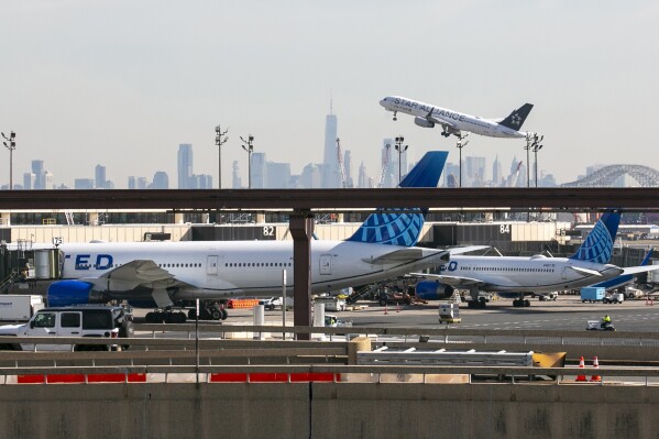 FILE A plane takes off from Newark Liberty International Airport in Newark, New Jersey, on Monday, February 27, 2023, with One World Trade Center and the lower Manhattan skyline visible in the background. The Federal Aviation Administration, which was heavily criticized for the way it approved the Boeing 737 Max before two deadly crashes, said Wednesday, July 26, 2023, that it is more clearly explaining the kind of critical safety information that must be disclosed to the agency. (AP Photo/Ted Shaffrey, File)