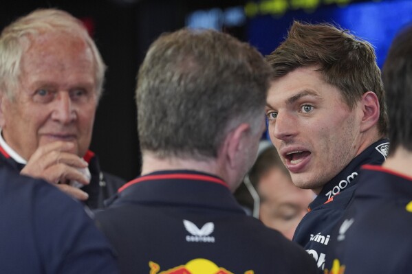 Red Bull driver Max Verstappen, right, of the Netherlands talks with director of the Red Bull racing Helmut Marko and team principal Christian Horner, centre, in the team garage following the first practice session of the Australian Formula One Grand Prix at Albert Park, in Melbourne, Australia, Friday, March 22, 2024. (AP Photo/Asanka Brendon Ratnayake)