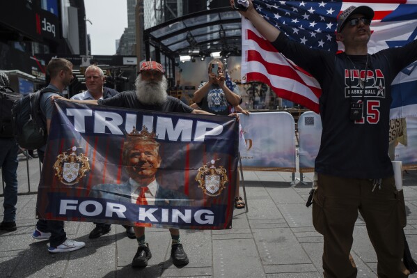 Supporters of President Donald Trump hold pro-Trump flags in Times Square during a protest against U.S. strikes on Iran, Sunday, June 22, 2025, in New York. (AP Photo/Olga Fedorova)
