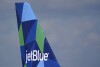 FILE - The tail of a JetBlue Airways Airbus A321 is shown as the plane prepares to take off from Fort Lauderdale-Hollywood International Airport, Tuesday, Jan. 19, 2021, in Fort Lauderdale, Fla.  An Associated Press analysis revealed the number of -Companies 