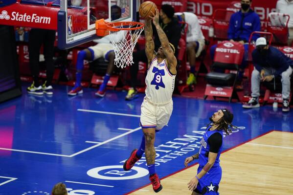 Philadelphia 76ers' Rayjon Tucker (9) goes up for a dunk against Orlando Magic's Cole Anthony (50) during the second half of an NBA basketball game, Sunday, May 16, 2021, in Philadelphia. (AP Photo/Matt Slocum)