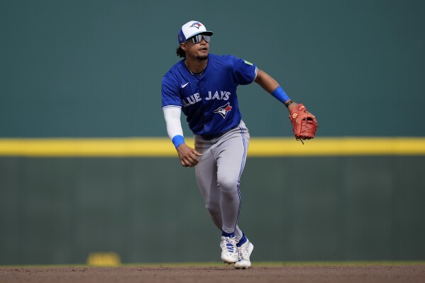 Toronto Blue Jays third baseman Santiago Espinal watches a fly ball in the sixth inning of a spring training baseball game against the Pittsburgh Pirates Tuesday, March 5, 2024, in Bradenton, Fla. (AP Photo/Charlie Neibergall)