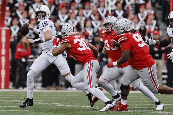 Ohio State defenders force Penn State quarterback Drew Allar out of the pocket during the second half of an NCAA college football game Saturday, Oct. 21, 2023, in Columbus, Ohio. (AP Photo/Jay LaPrete)