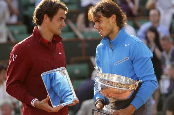 FILE - In this June 5, 2011, file photo, Spain's Rafael Nadal, right, and Switzerland's Roger Federer pose with their trophies after the men's final match for the French Open tennis tournament at Roland Garros stadium in Paris. This year's French Open will be the first since 1998 with neither Rafael Nadal nor Roger Federer in the field. (AP Photo/Lionel Cironneau, File)