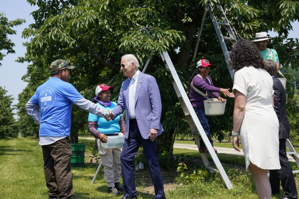 FILE - President Joe Biden meets with workers as he tours King Orchards fruit farm, July 3, 2021, in Central Lake, Mich. Biden has landed farmworkers' union endorsement. (AP Photo/Alex Brandon, file)
