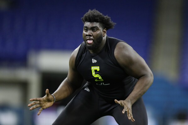 FILE - Louisville offensive lineman Mekhi Becton runs a drill at the NFL football scouting combine in Indianapolis, Feb. 28, 2020. Becton has agreed to terms with the Philadelphia Eagles on a one-year contract worth up to $5.5 million, two people familiar with the deal told The Associated Press on Sunday, April 28, 2024. (AP Photo/Michael Conroy, File)