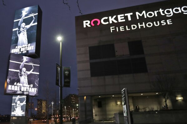FILE - In this Jan. 28, 2020, file photo, images of Kobe Bryant are displayed as fans enter Rocket Mortgage Fieldhouse for an NBA basketball game between the Cleveland Cavaliers and the New Orleans Pelicans in Cleveland. The Rock & Roll Hall of Fame announced Tuesday, March 2, 2021, that the 2021 induction ceremony will take place at Rocket Mortgage FieldHouse in Cleveland on October 30. (AP Photo/Tony Dejak, File)