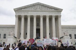 Demonstrators gather outside the Supreme Court in Washington, Thursday, June 23, 2016. In a major victory for affirmative action, a divided Supreme Court upheld the University of Texas admissions program that takes account of race. The justices voted in favor of the Texas program by a 4-3 vote, an outcome that was dramatically altered by the death of Justice Antonin Scalia, who opposed affirmative action. (AP Photo/Evan Vucci)