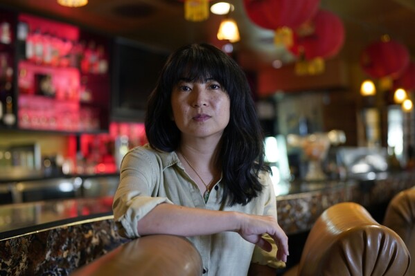 Ashley Cheng poses for a photo at her father's restaurant, Chinatown, in Austin, Texas, Wednesday, June 28, 2023. Cheng, the founding president of Asian Texans for Justice, recalls discovering her mother was not listed in the voter rolls when she tried to help her vote in 2018. They never found out why she wasn’t properly registered. Advocates say this highlights flaws in the system and illustrates how volunteers are essential to overcoming them. (AP Photo/Eric Gay)