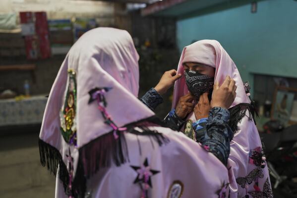 Revelers, known as sayones, prepare to take part in an Easter celebration, in Tetela del Volcan, Mexico, Sunday, April 20, 2025. (AP Photo/Eduardo Verdugo)