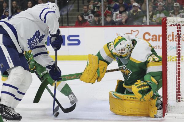 Toronto Maple Leafs center David Kampf (64) tries to score a goal against Minnesota Wild goaltender Marc-Andre Fleury (29) during the second period of an NHL hockey game Friday, Nov. 25, 2022, in St. Paul, Minn. (AP Photo/Stacy Bengs)