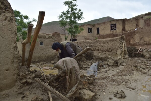 An elderly man collects his belongings from his damaged home after heavy flooding in Baghlan province in northern Afghanistan Saturday, May 11, 2024. Flash floods from seasonal rains in Baghlan province in northern Afghanistan killed dozens of people on Friday, a Taliban official said. (AP Photo/Mehrab Ibrahimi)