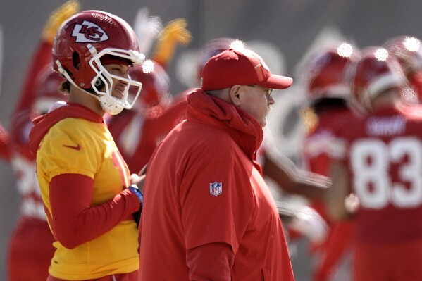 Kansas City Chiefs quarterback Patrick Mahomes, right, and head coach Andy Reid watch practice for Super Bowl 58 Friday, Feb. 9, 2024 in Henderson, Nev. (AP Photo/Charlie Riedel)