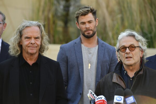 From left, Producer Doug Mitchell, actor Chris Hemsworth and director George Miller attend at a press conference to announce the new "Mad Max" film at Fox Studios Australia in Sydney, Monday, April 19, 2021. (Mick Tsikas/AAP Image via AP)