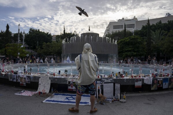 A Jewish man covered in a prayer shawl prays at a vigil for the victims of the bloody Oct. 7 cross-border attack by Hamas militants in central Tel Aviv, Israel, Saturday, Nov. 11, 2023. (AP Photo/Oded Balilty)