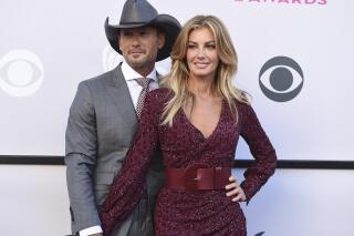 FILE - Tim McGraw, left, and Faith Hill appear at the 52nd annual Academy of Country Music Awards in Las Vegas on April 2, 2017. The country music stars, married with kids for more than two decades, play a couple heading west with their children in search of opportunity in "!883." The Paramount+ series debuts Sunday on the streaming service. (Photo by Jordan Strauss/Invision/AP, File)