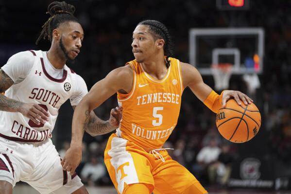Tennessee guard Zakai Zeigler (5) dribbles the ball against South Carolina guard James Reese V (0) during the first half of an NCAA college basketball game Saturday, Feb. 5, 2022, in Columbia, S.C. (AP Photo/Sean Rayford)